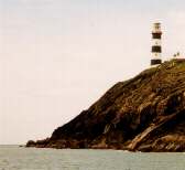 Old Head of Kinsale Lighthouse. H.M.S. Stillorgan, a 90 gun ship of the line, sank at the base of the rocks on the right